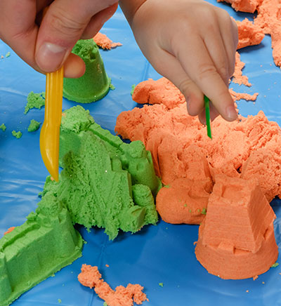 Kids making castles with kinetic sand
